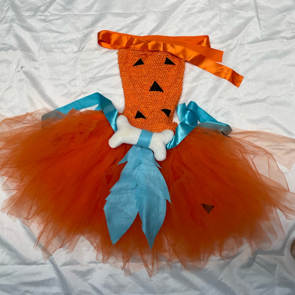 Orange, black, and blue cave girl costume